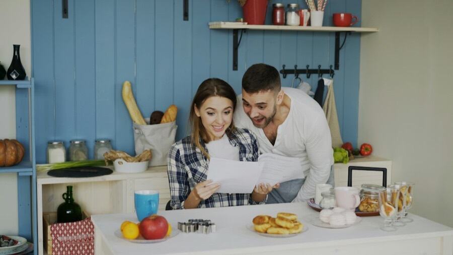Couple reviewing paperwork at their kitchen table